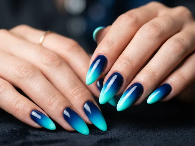 Midnight blue nails fading into fluorescent aqua neon tips